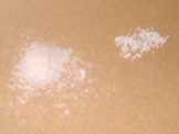 A pile of powder and a pile of spheroids